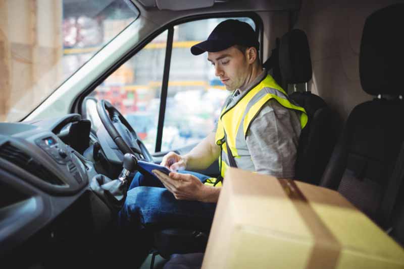 delivery driver sat in his car about to deliver a parcel