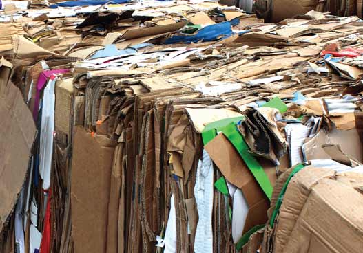 large pile of compacted cardboard recyclable waste